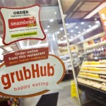 GrubHub and Seamless stickers cover many doors, indicating that the restaurants are online.
