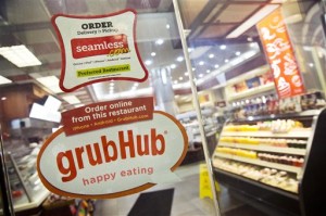 GrubHub and Seamless stickers cover many doors, indicating that the restaurants are online.   