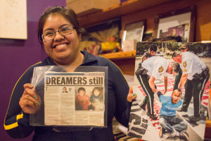 Yajaira Saavedra, 25, holds a news article about her and her brother, Marcos. 