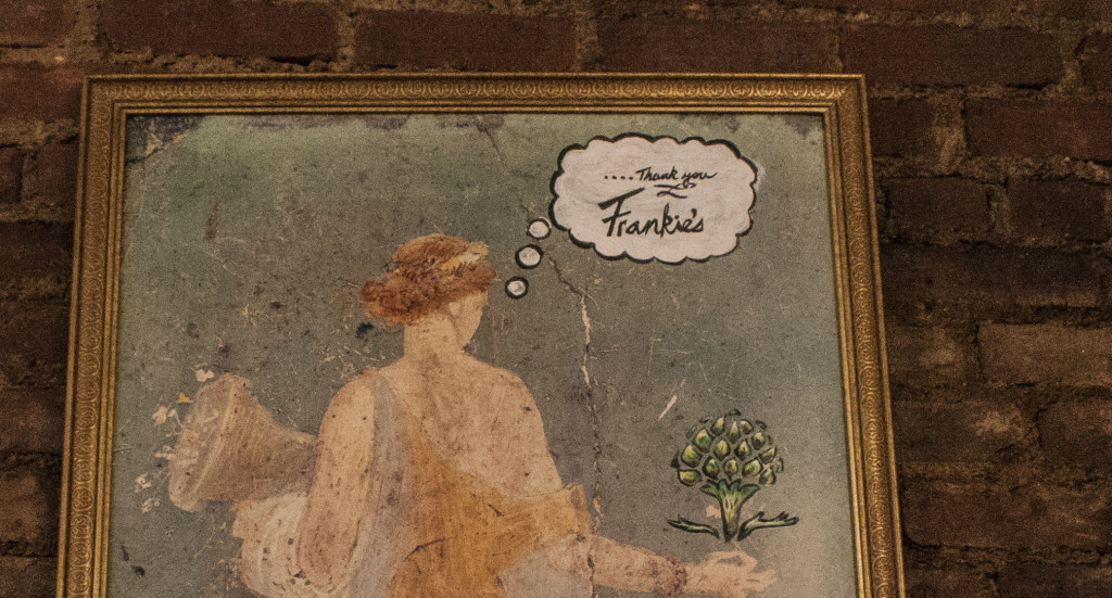 A painting that hangs in Artichoke Basille Pizza. The speech bubble reads _Thank you Frankies_ 1