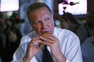 Republican presidential candidate, former Ohio Gov. John Kasich, takes a bite out of a fish sandwich for lunch at the Original Oyster House restaurant in downtown Pittsburgh, Tuesday, April 19, 2016.  (AP Photo/Gene J. Puskar)