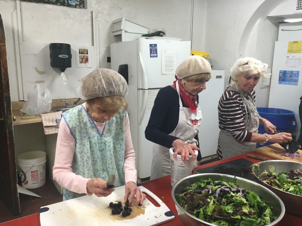 Volunteers prepare a salad for the Thursday lunch offered at St. George's Common Table. Photo: Lindsay Purcell.