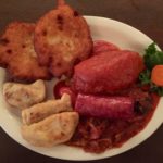 The plate of Polish specialties – three pierogis, two potato pancakes, polish kielbasa, hunter’s stew and stuffed cabbage.