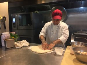 Lopez preparing the pizza dough for family meal. Photo: Margie Merritt. 