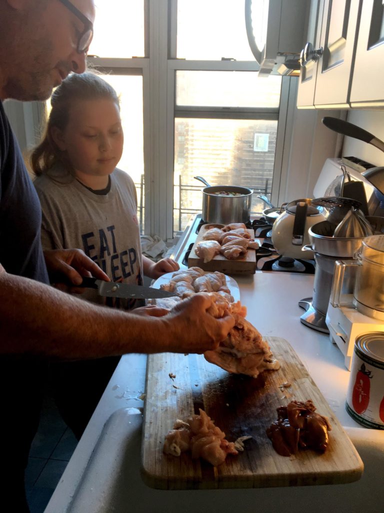 Neil Kleinberg and his daughter, Jade, butchering the chicken that they'll use for dinner.