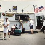 Paul Sr. standing in front of a Paul's Dogs food truck. Photo courtesy: Paul Heyne Jr.