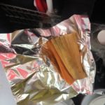 Guerrero and Rueda's tamales can be eaten immediately while standing at their cart, or can be taken to-go wrapped up in foil; here is a rojo picante with spicy pork and a verde with chicken and green sauce. Photo: Maura Whang.