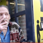 Ira Stolzenburg, oldest surviving vendor at the Essex Street Market enjoys a cigarette outside of the old market building.